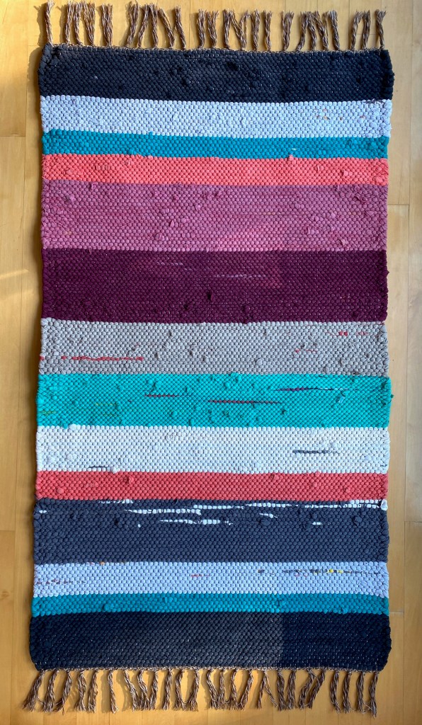 Rag rug rug with thick stripes in burgundy, rose, orange, green, black gray, beige